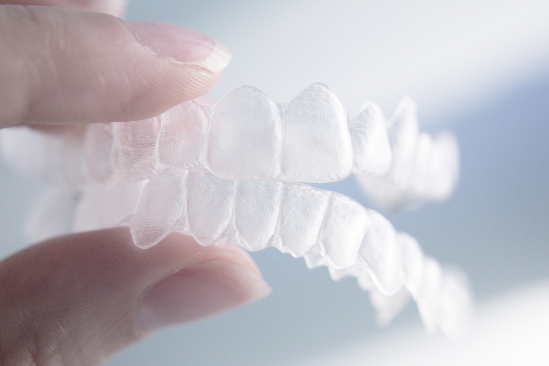 Invisalign clear aligner in hand