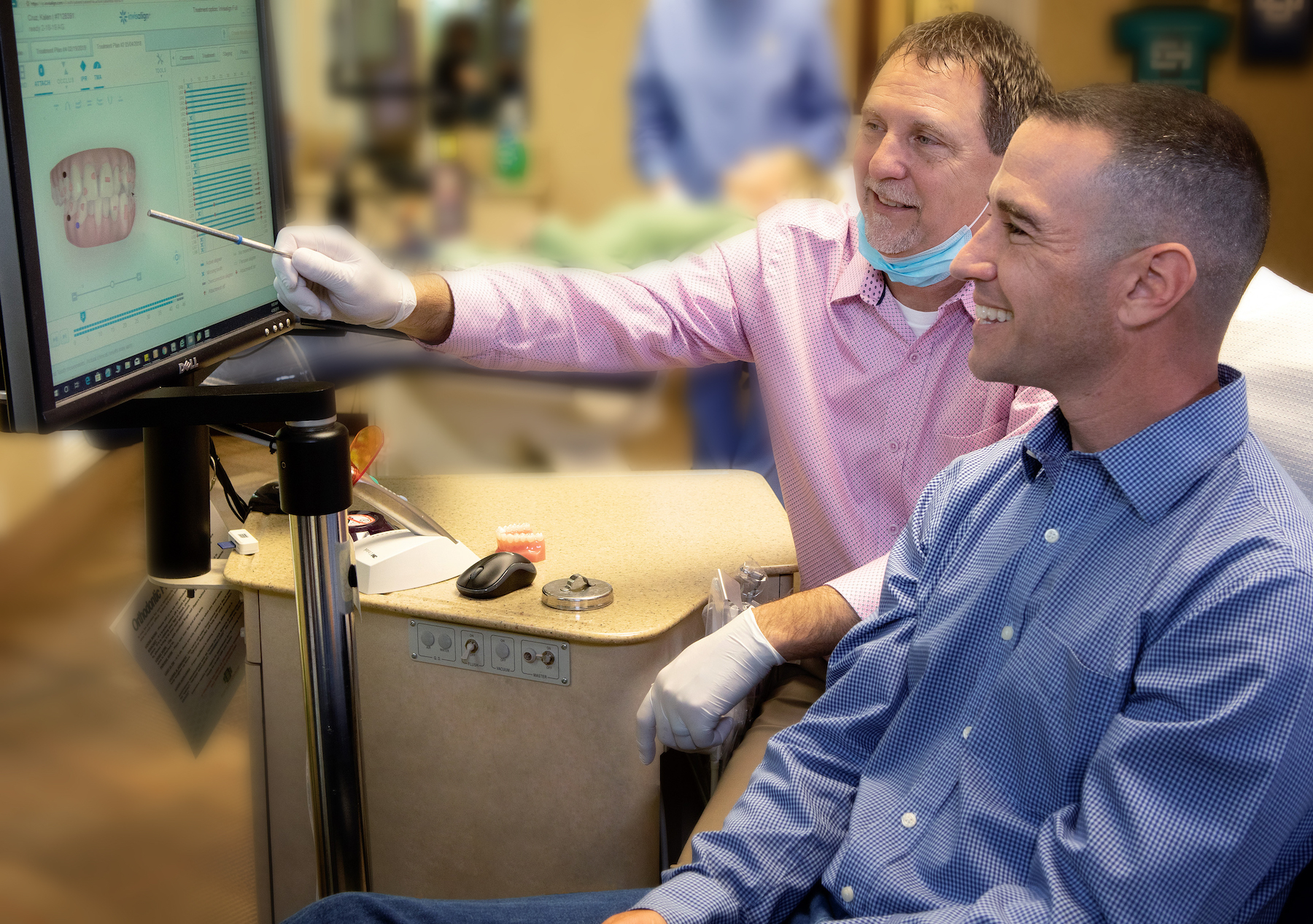 Dr. Spillers, Spillers Orthodontics, patient smiling, orthodontist teaching, pointing at screen, two men
